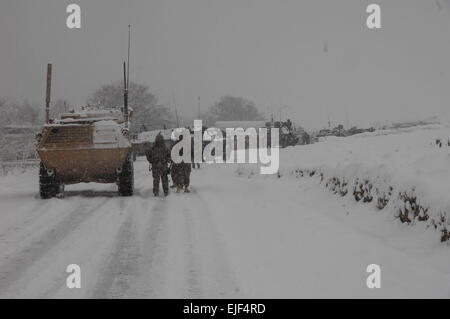 U.S. Army Soldiers from Bravo Company, Special Troops Battalion, Task Force Gladius, Forward Operating Base Morales Frasier, along with French and Afghan army soldiers set up their security positions during a key leader engagement in Jalokheyl village located on the main supply route Vermont, Tagab District, Kapisa Province, Afghanistan, Feb. 5, 2008.   Sgt. Johnny R. Aragon Stock Photo