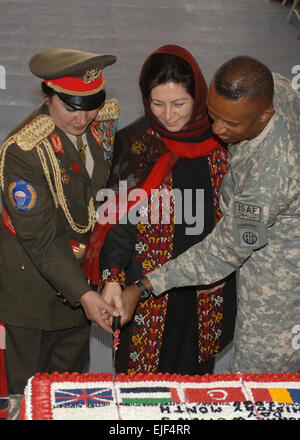 From left, Afghan National Army Brig. Gen. Khatool Mohammadzai, Dr. Husn Banu Ghazanfar, from the Ministry of Women's Affairs; and U.S. Army Brig. Gen. Rodney Anderson, the deputy commanding general - support of Combined Joint Task Force-82, cut a cake during an international women's day celebration on Bagram Air Base, Afghanistan, March 3, 2008.  Master Sgt. Demetrius Lester, U.S. Air Force. Stock Photo