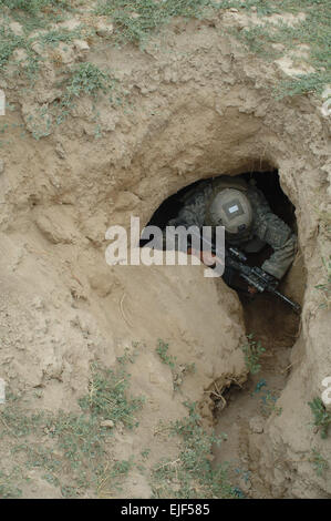 U.S. Army Spc. William Fowler enters a cave during operations near the village of Kuz Khadow Kheyl, Afghanistan, June 8, 2007.  Staff Sgt. Justin Holley Stock Photo