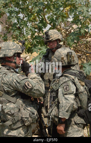 U.S. Army 1st Lt. John Norden and Sgt. Brendan Johnson, from the Headquarters, Headquarters Battery, 4th Battalion, 319th Airborne Field Artillery Regiment, 173rd Airborne Brigade Combat Team, talk to 2nd Lt. Jonathon Reabe, from Charlie Company, 1st Battalion, 158th Infantry Regiment, Arizona National Guard, about returning to their vehicle patrol base because of heat casualties that occurred while on a joint patrol to a village in the Titin Valley of the Nuristan province of Afghanistan June 21, 2007. U.S. Army photo Staff Sgt. Isaac A. Graham Stock Photo