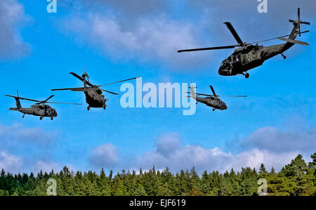 Four UH-60 Black Hawk helicopters provide air support for Soldiers conducting an air assault exercise as part of the Full Spectrum Training Event in Hohenfels, Germany, Oct. 14, 2011. The UH-60 crews are assigned to the 12th Combat Aviation Brigade-Europe.  Richard Bumgardner Stock Photo