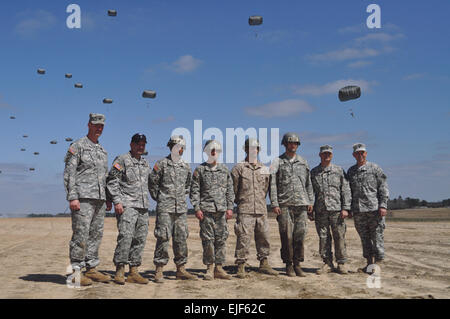 Members of the command team from 1st Battalion Airborne, 507th Parachute Infantry Regiment, pose with the Airborne students who jumped first with the new T-11 parachute. Based on the original parachute test platoon, predecessor of the 501st Parachute Infantry Battalion, the first jump students were chosen by lottery. Pictured from left are C Company first sergeant, 1st Sgt. Christopher Goodrow; battalion command sergeant major, Command Sgt. Maj. Chippy Mezzaline; Pfc. Rincon Santos; Pfc. Jonathan Whitley; Marine Cpl. David Chapman; 2nd Lt. Charles Lesperance; C Company commander, Capt. Dean Gi Stock Photo