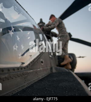 Sgt. Casey R. Ogden, a crew chief with 4th Battalion, 227th Aviation Regiment, 1st Cavalry Division, performs pre-flight checks on a U.S. Army AH-64D Apache helicopter on the USS Ponce in the Arabian Gulf, Dec. 9, 2013. The 4-227th from Fort Hood, Texas is currently deployed with the 36th Combat Aviation Brigade Texas Army National Guard to the Middle East in support of Operation Enduring Freedom.  Sgt. Adam C. Keith, U.S. Army Central