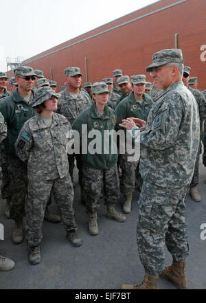 KANDAHAR AIRFIELD, Afghanistan-- Army Chief of Staff, Gen. George W. Casey talks to Spc. Luis M. Perez Salazar, patient administration clerk, 2nd Striker Cavalry Regiment, assigned to the Multi-National Medical Unit Dec. 23 during a tour of the medical facility. Gen. Casey presented Salazar with a coin, a long time tradition since World War I to recognize Soldiers for their accomplishments.   Staff Sgt. LaSonya Morales, 16th Mobile Public Affairs Detachment Stock Photo