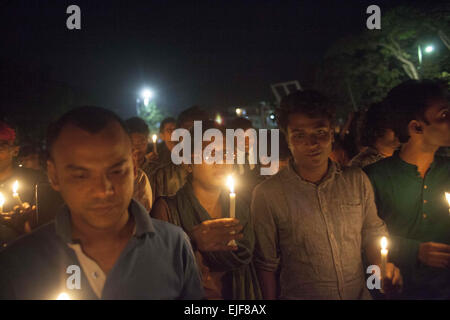 Dhaka, Bangladesh. 25th Mar, 2015. Dhaka, Bangladesh, Wednesday, March 25, 2015 ; Bangladeshi social activists hold candles during a rally in remembrance of those who were killed on this night in 1971, a day ahead of the country's declaration of independence from Pakistan.On this black night in the nationl history, the Pakistani military rulers launched ''Operation Searchlight'' killing some thousand people in that night crackdown alone. As part of the operation, tanks rolled out of Dhaka cantonment and a sleeping city woke up to the rattles of gunfire as the Pakistan army attacked the ha Stock Photo