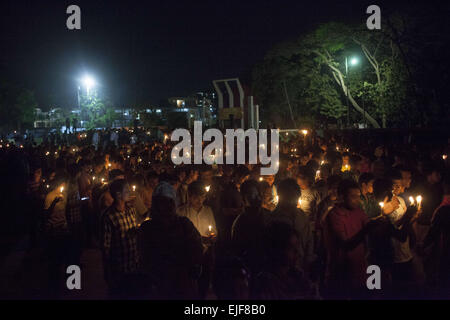 Dhaka, Bangladesh. 25th Mar, 2015. Dhaka, Bangladesh, Wednesday, March 25, 2015 ; Bangladeshi social activists hold candles during a rally in remembrance of those who were killed on this night in 1971, a day ahead of the country's declaration of independence from Pakistan.On this black night in the nationl history, the Pakistani military rulers launched ''Operation Searchlight'' killing some thousand people in that night crackdown alone. As part of the operation, tanks rolled out of Dhaka cantonment and a sleeping city woke up to the rattles of gunfire as the Pakistan army attacked the ha Stock Photo