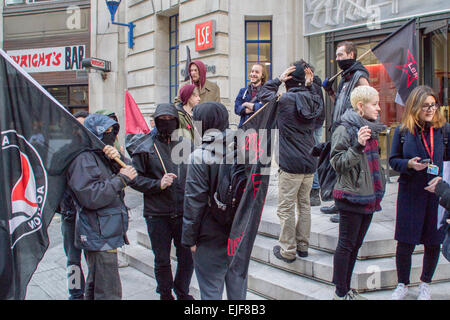 Houghton Street, London, UK - 25th March 2015: Protesters dressed in black outside the LSE Old Building at the start of the Stop The Cuts march from London School of Economics to the London College of Communication in Elephant and Castle. Stock Photo