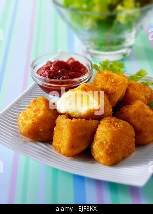 Deep fried camembert cheese in bread crumbs with salad Stock Photo