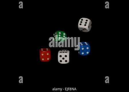 Tumbling dice isolated against a black background Stock Photo