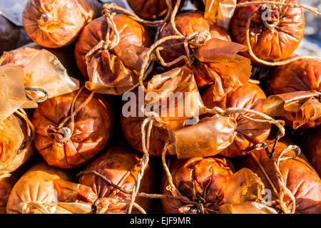 A stack of dry cured and smoked sausage in their skins Stock Photo