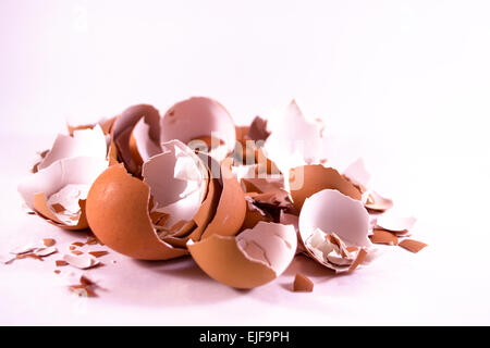 A pile of smashed crushed and broken eggshells on white background Stock Photo