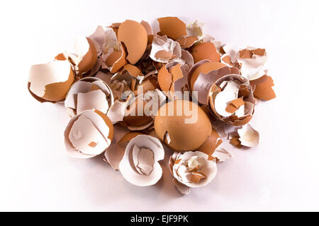 A pile of smashed crushed and broken eggshells on white background Stock Photo