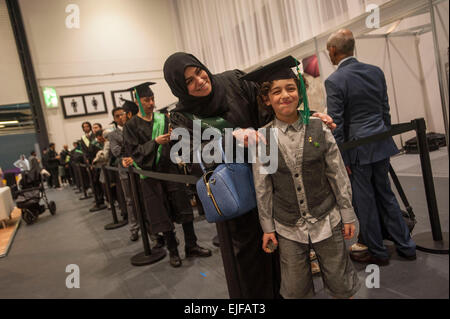 Queuing for their graduation snap    Saudi Arabian nationals at The Saudi Arabian Cultural Bureau hosted 5th Graduation Ceremony & Career Fair 22nd of March 2015, Excel Centre London. All have attended university in the UK and are now looking to return to Saudi Arabia for work. Stock Photo