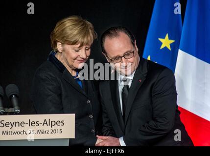 Seyne, France. 25th Mar, 2015. French President Francois Hollande (R) shakes hands with German Chancellor Angela Merkel during a press conference in Seyne-les-Alpes, France, March 25, 2015. © Chen Xiaowei/Xinhua/Alamy Live News Stock Photo