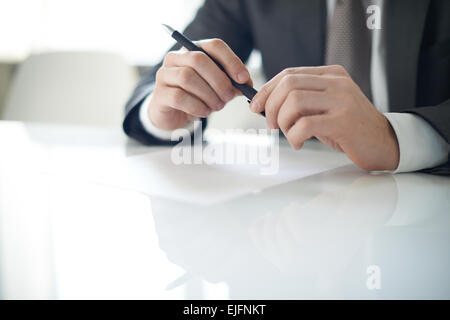 Man holding pen in his hands Stock Photo