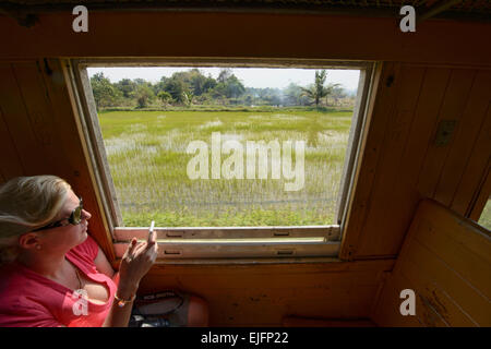 Riding the tourist train commemorating the Burma Death Railway near Kanchanaburi, Thailand Stock Photo