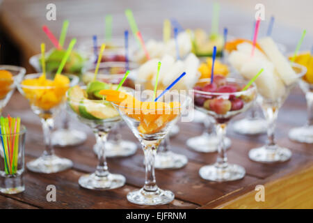 Fresh tasty fruit cuts in champagne glasses Stock Photo