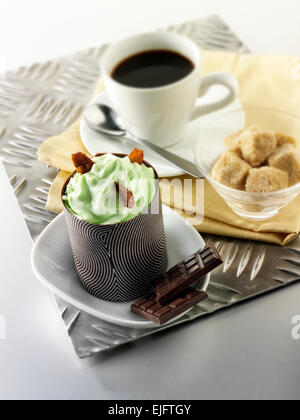 mint mousse cake in a decorated chocolate case with coffee Stock Photo