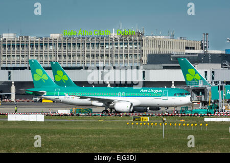 Aer Lingus airbus planes on tarmac with Dublin Airport sign and terminal 1 behind Stock Photo