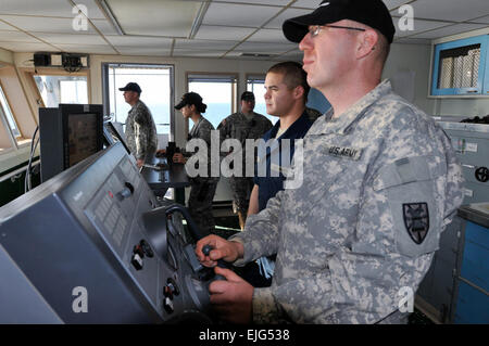 Army mariners assigned to Logistic Support Vessel-4, the Lt. Gen. William B. Bunker, 1099th Transportation Detachment, 10th Trans. Battalion, 7th Sustainment Brigade man the bridge as it sails the James River toward Joint Expeditionary Base Little Creek the afternoon of Feb. 7 as part of the battalion's Field Training Exercise.  Sgt. 1st Class Kelly Jo Bridgwater, 7th Sustainment Brigade Public Affairs Stock Photo