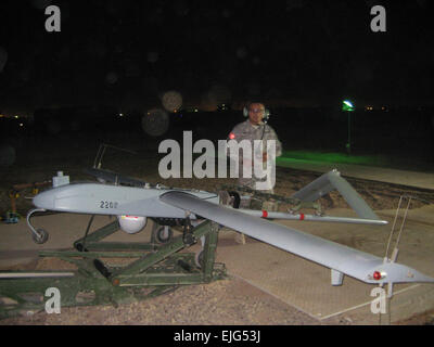 Sgt. Neal Naputo, a native of Zambales, Philippines, prepares to launch an unmanned aerial vehicle at Camp Taji, northwest of Iraq, Nov. 15.  Naputo is the oldest of six children. Prior to joining the Army, he worked as a commercial spear fisherman. His hobbies consist of chess playing, where he once was a member of the All-Army Chess team, and playing guitar at the Tigris River Chapel.  He serves as a technician for the Tactical Unmanned Aerial Systems Platoon assigned to Troop D &quot;Diamondback,&quot; 2nd Squadron, 14th Cavalry Regiment &quot;Strykehorse,&quot; 2nd Stryker Brigade Combat T Stock Photo