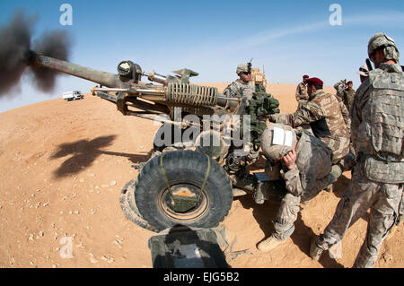 U.S. and Iraqi artillerymen fire American 105 mm howitzers during live-fire training on Al Asad Air Base, Iraq, Feb. 21, 2010. The U.S. troops are paratroopers assigned to the 82nd Airborne Division's 3rd Battalion, 319th Airborne Field Artillery Regiment, 1st Brigade Combat Team, an Advise and Assist Brigade.  Spc. Michael J. MacLeod Stock Photo