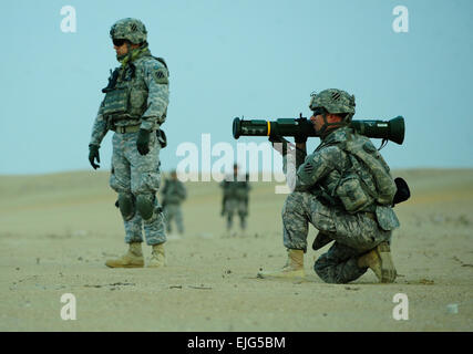 Sgt. Quentin Deckard, an infantryman assigned to Headquarters and Headquarters Company, 3rd Brigade Special Troops Battalion, 3rd Armored Brigade Combat Team, 3rd Infantry Division fires an AT-4, an anti-tank weapon, at the Udairi Range Complex near Camp Buehring, Kuwait, Dec. 20. The AT-4 is a portable, single-shot recoilless smoothbore weapon used to destroy heavily armored vehicles. Stock Photo