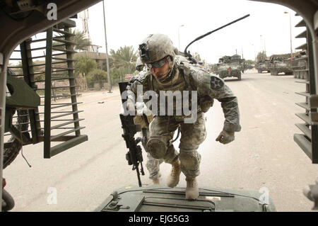 U.S. Army Spc. Solis enters a Stryker assault vehicle after completing a clearing mission in Baghdad, Iraq, May 6, 2007. Solis is assigned to the 2nd Battalion, 3rd Infantry Brigade Combat Team.  Tech. Sgt. Cecilio M. Ricardo Jr. Stock Photo