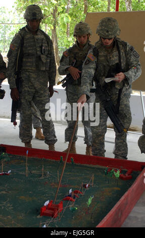 From right, U.S. Army Staff Sgt. Christopher Jenkins and Sgts. Allen Hustin and Karl Smalls review a sand table April 10, 2008, during a training exercise at Rajendrapur Cantonment, Bangladesh. The Soldiers are assigned to 1st Platoon, 57th Military Police Company, 8th MP Brigade from Schofield Barracks, Hawaii.  Sgt. David House, Stock Photo