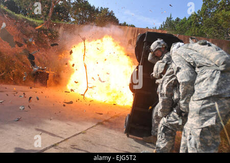 Spc. Wesley A. Coble and Sgt. Victor Alcantar, combat engineers assigned to 1st Platoon, 43rd Engineer Company, 2nd Squadron “Sabre”, 3d Cavalry Regiment, find cover behind a “blast blanket” after detonating an entryway with explosives July 31 at a subterranean tunnel complex on Fort Hood. The Soldiers were taking part in a training event designed to develop tactics, training, and procedures for emerging battlefields.   Pfc. Erik Warren, 3d Cavalry Regiment Public Affairs Stock Photo