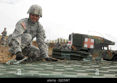 Spc. Elizabeth Matos, 892nd MRBC, 190th En. Bn., Puerto Rico National Guard, helps assemble a bridge during unit certification. The Soldiers are currently training with recently acquired bridges while their personnel get certified in operation, assembly and disassembly.  Staff Sgt. Joseph Rivera Rebolledo Stock Photo
