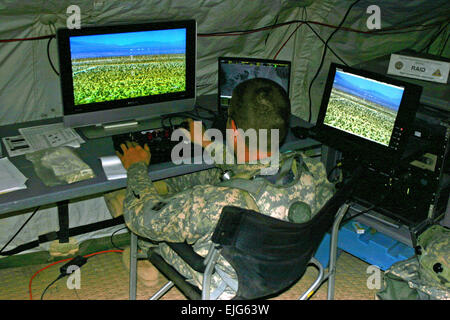 A Soldier from the 2nd Brigade Combat Team, 4th Infantry Division, operates the rapid aerostat initial deployment, part of Integrated Base Defense System of Systems, in the base defense operations center at the National Training Center, Fort Irwin, Calif.  Casey Bain Stock Photo