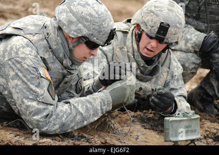 U.S. Army soldiers assigned to the 18th Combat Sustainment Support Battalion set up an M18A1 claymore anti-personnel mine during live-fire training at Grafenwoehr Training Area in Germany on Sept. 29, 2010.   Gertrud Zach, U.S. Army. Stock Photo
