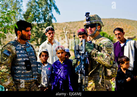 U.S. Army 1st Lt. Matthew Hickey, from Saint Paul, Minn., assigned to A Battery, speaks with local Afghan nationals while out on patrol April 7. A Battery is part of the 2nd Bn., 377 Parachute Field Artillery Regiment, Task Force Spartan Steel.  U.S. Army Spc. Eric-James Estrada Stock Photo