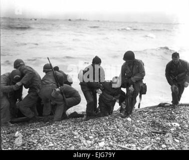 Members of a landing party help injured Soldiers to safety on Utah Beach during the Allied Invasion of Europe on D-Day, June 6, 1944.  /d-day  /d-day Stock Photo