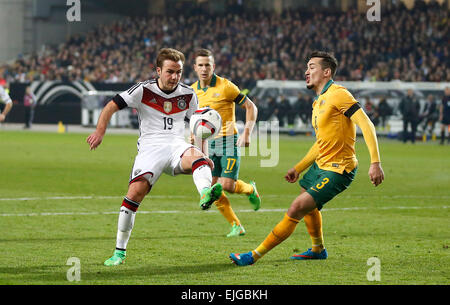 Germany's Mario Goetze (FC Bayern Muenchen) (L) against Jason Davidson (West Bromwich Albion) during the friendly match between Germany and Australia, Fritz-Walter-Stadion in Kaiserslautern on March 25., 2015. Stock Photo