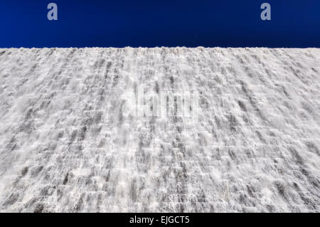 Water cascading down Derwent dam in the Peak District, Derbyshire. A sunny spring day. Stock Photo