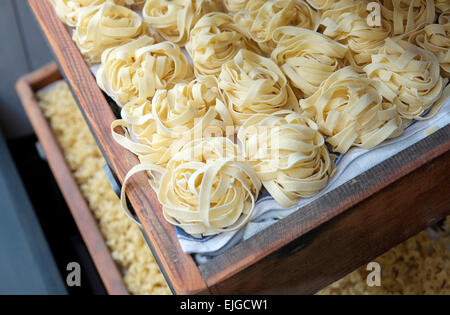 tagliatelle pasta in wooden trays in italian restaurant window Stock Photo