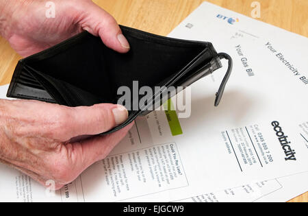 pensioner holding open empty wallet Stock Photo