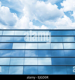 Modern office facade perspective. Blue mirrored glass and cloudy sky Stock Photo
