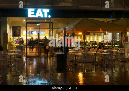 Branch of Eat sandwich shop on the Southbank in London at night in the rain. Stock Photo