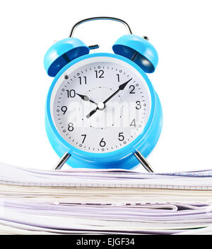 Alarm clock over the pile of papers Stock Photo