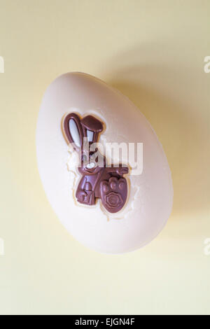 Thorntons Harry Hopalot white chocolate Easter bunny rabbit egg isolated on yellow background - ready for Easter Stock Photo