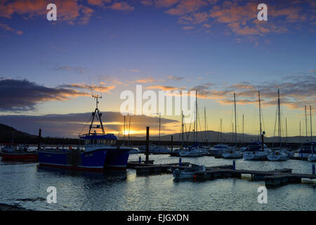 Lough Swilly, County Donegal. 26th March, 2015. Ireland Weather: The setting sun over Lough Swilly and Fahan marina, County Donegal at the end of a cold and cloudy Spring day. Credit:  George Sweeney/Alamy Live News Stock Photo