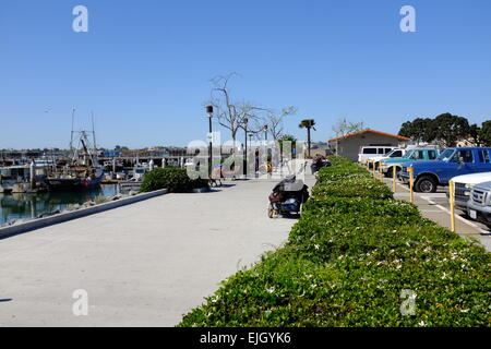 USS Midway on the waterfront in San Diego, and statue of Sailor Kissing Girl at the end of World War II Stock Photo