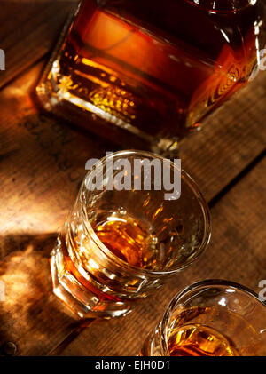 close up view of  nice bottle and two glasses filled with whiskey Stock Photo