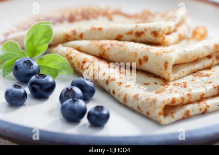 close up view of nice yummy crepes with blueberry on table Stock Photo