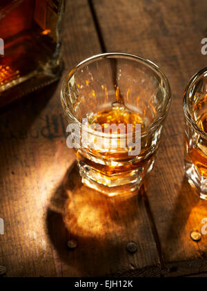 close up view of  nice bottle and two glasses filled with whiskey Stock Photo