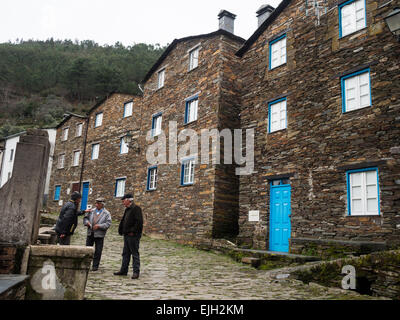 Old man taking on the street in Piodão hamlet in Aço mountain Stock Photo