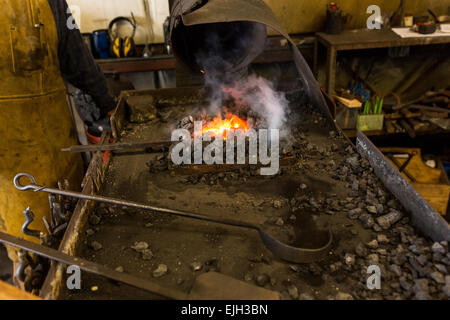 A blacksmith forge and metal working tools at a iron working shop in Charleston, SC Stock Photo